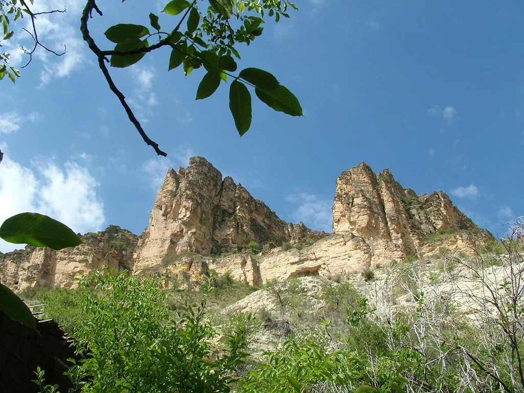 Pale layered cliffs rising above leafy trees in İnözü Vadisi near Beypazarı