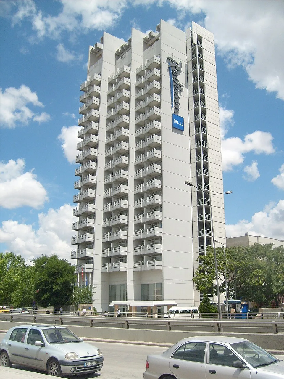 White Radisson Blu Hotel Ankara tower with balconies above the road in Ulus