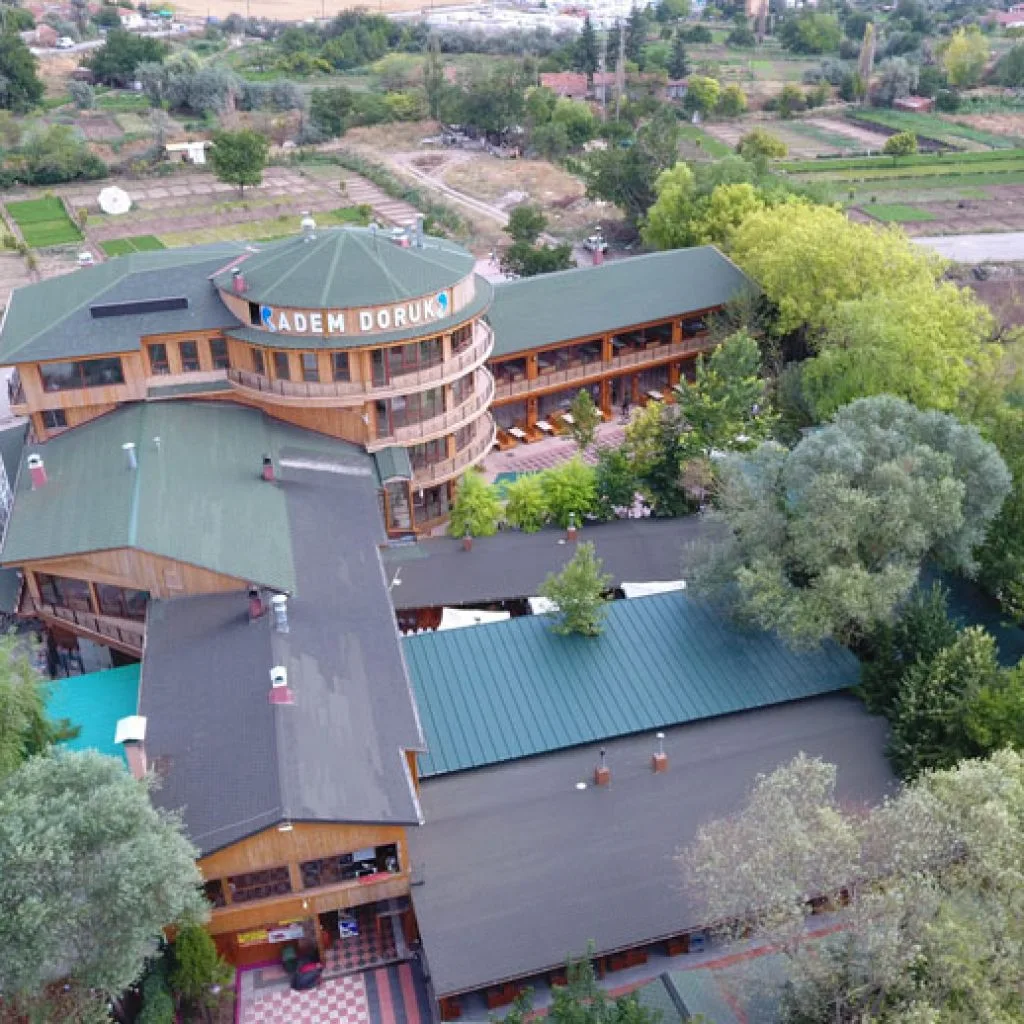 Aerial view of the İvedik restaurant buildings with green roofs surrounded by trees