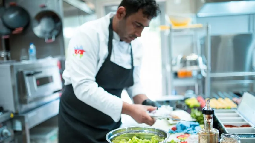 Chef preparing food at Buta Baku Cafe